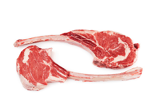 Raw tomahawk steak isolated on white background