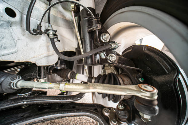 istock View of car suspension system and various components tie rod end, axle assembly, shock absorber, strut assembly and alignment cam bolt as well as strut mount, control arm, and brake pad with rotor. 1453859125