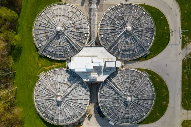 Photo of Aerial view of waste water treatment plant. Drinking tap water treatment process. Drinking bottle water production and distribution, filtration and cleaning.