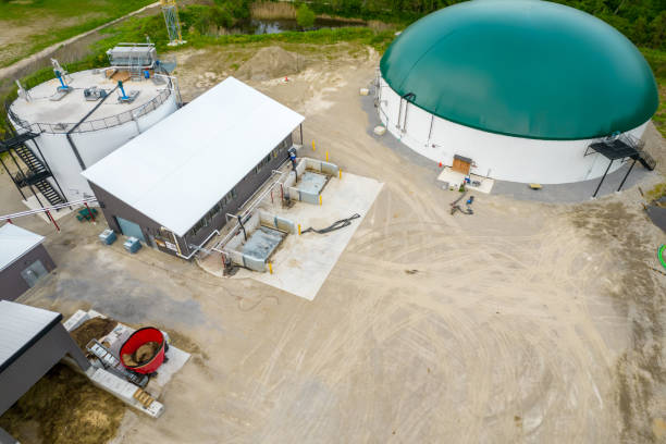 Industrial plant for production bio energy from animal manure and organic waste. Organic fuel pilot project. Round green top of fuel reservoirs of biogas and production of safe energy. stock photo
