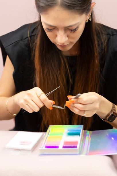 istock Young woman arranging colorful eyelashes set 1453862061