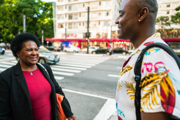 istock business man and woman talking on sidewalk 1453862216