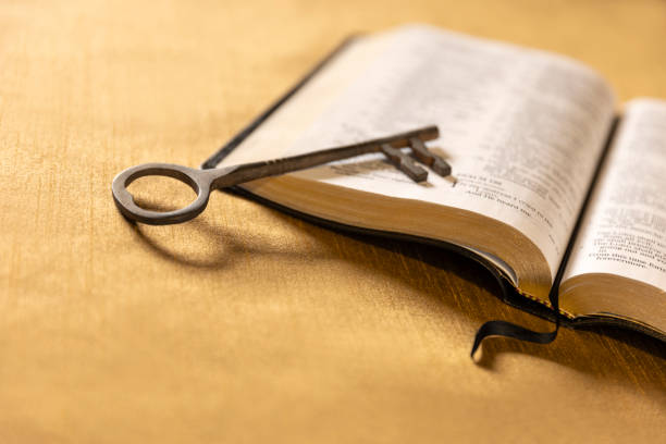 istock Bible on Retro Golden Background with a Skeleton Key 1453862273