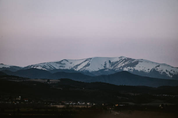 blick auf den teilweise verschneiten krnzna-gipfel von der stadt zvolen in der slowakei während der blauen stunde - zvolen stock-fotos und bilder