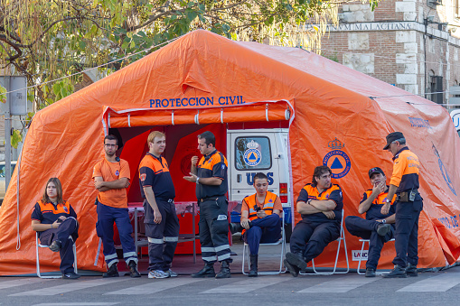 Alcala de Henares, Madrid, SPAIN - May 2, 2022: tent and members of the spanish civil protection service of alcala de henares  during the celebration of the traditional cervantine market of the city