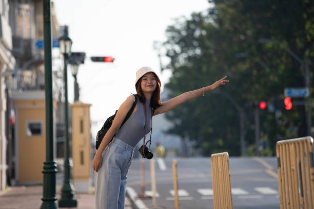 istock female tourist hitchhiking 1453866639