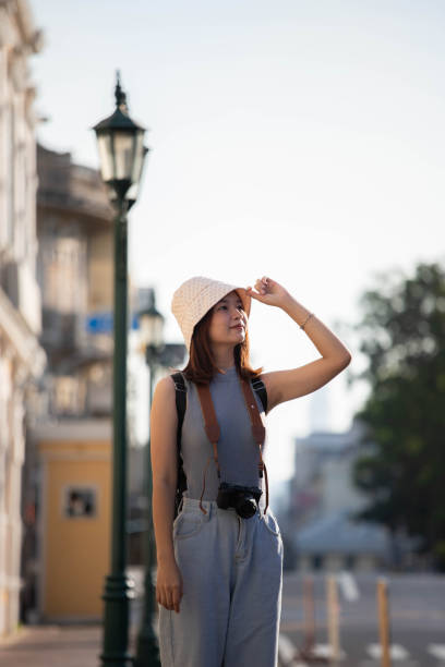 istock Female tourist holding a hat and looking away 1453866663