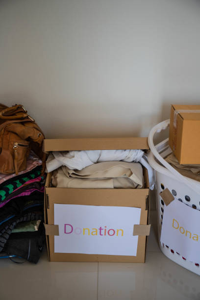 istock A close-up view of cardboard boxes containing old clothes for donation 1453866921