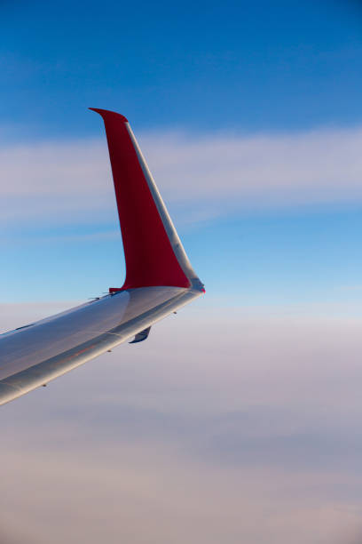 istock Red airplane wing and clouds, close up 1453867282