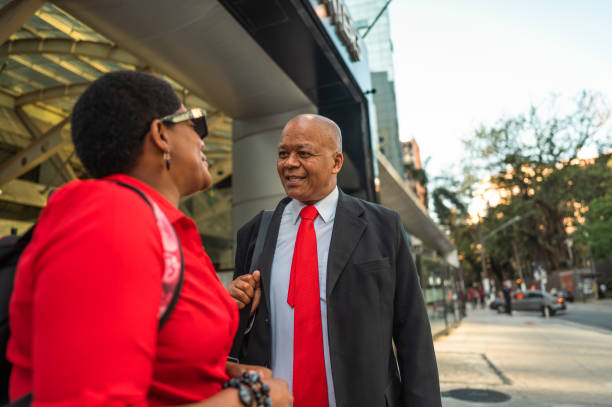 istock business man and woman talking and smiling 1453868267