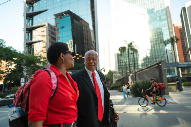 istock business man and woman walking and talking going to work 1453868286