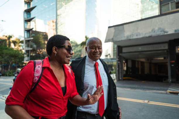 istock business man and woman walking and talking going to work 1453868291