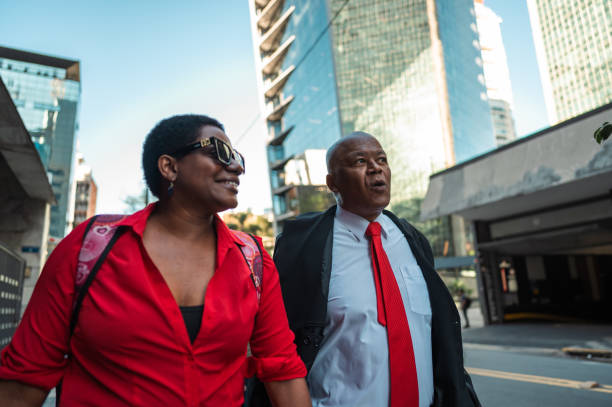 istock business man and woman walking and talking going to work 1453868311