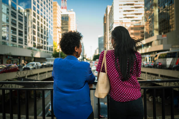 istock Friends at work talking and admiring the cityscape 1453868320