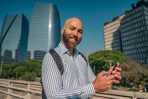 business man using smartphone and smiling