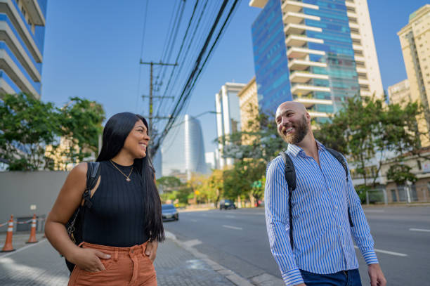 istock business man and woman walking to work and talking 1453868652