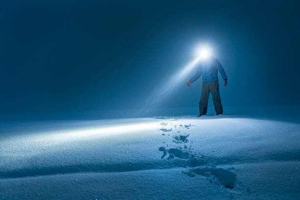 istock Man in deep snow at night searching for the road. 1453869472
