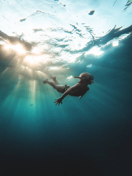 Caucasian Kid Swimming Underwater With Snorkeling Goggles