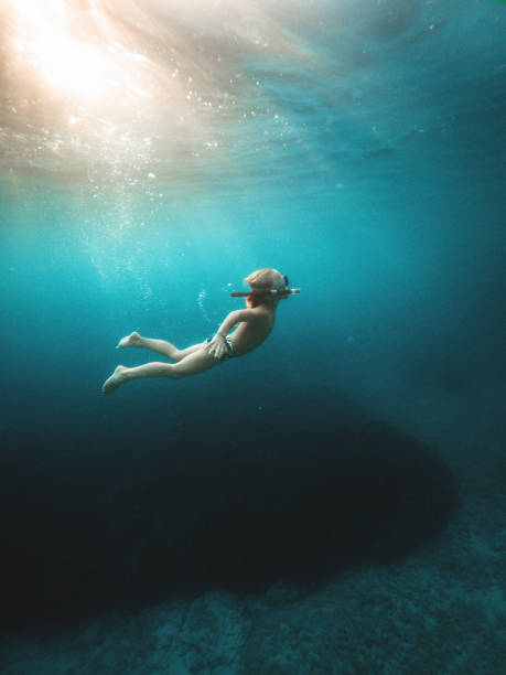istock Young Caucasian Kid Diving Underwater With Snorkeling Equipment 1453869476