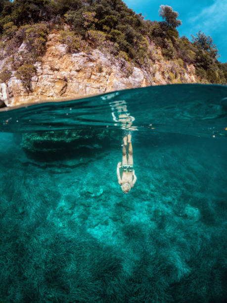 istock Young Caucasian Child Diving Vertically Underwater 1453869489