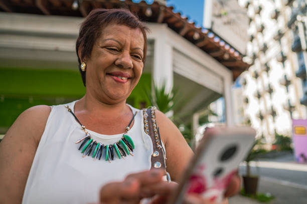 istock Business woman with cell phone smiling 1453869550