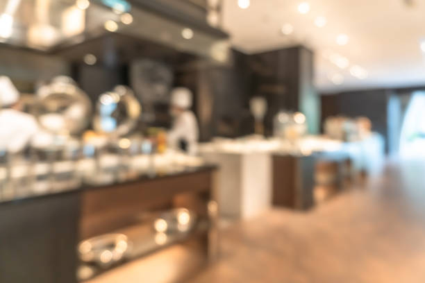istock Open kitchen blur background in luxury hotel restaurant facility showing chef cooking over blurry food counter for buffet catering service 1453869640