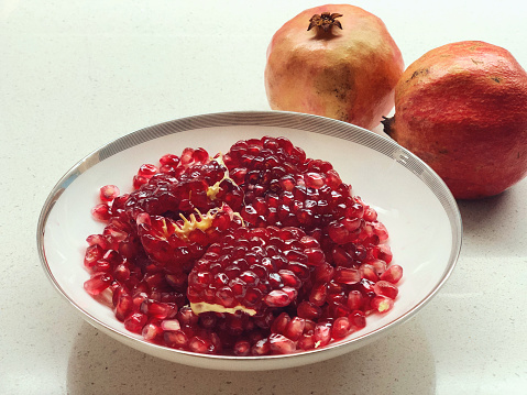 Ripe pomegranates on trees in the garden, with copy space