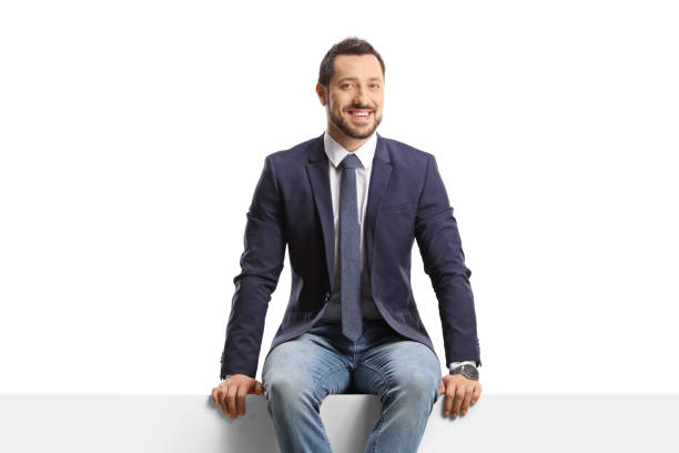 istock Man in jeans and suit sitting on a blank panel 1453872991