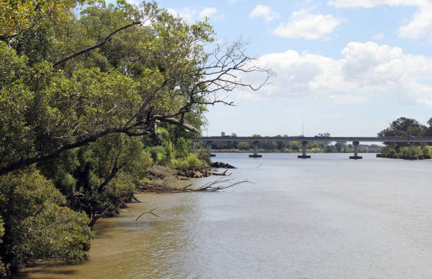 A railway trestle  crossing the Red River between the U.S. states of Texas and Oklahoma on a bright summer afternoon.