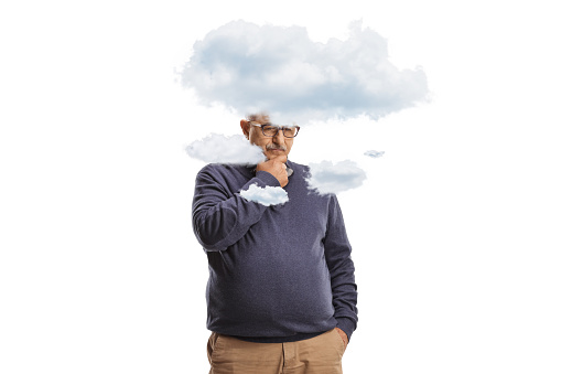 Mature man standing and thinking with clouds around his head isolated on white background