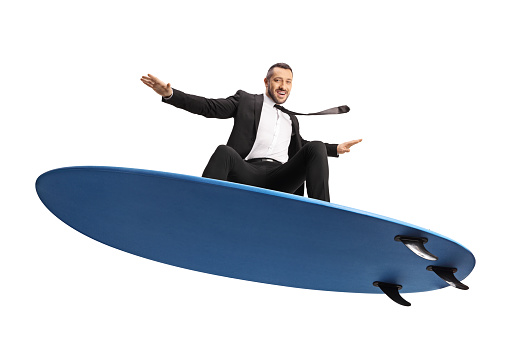 Businessman surfing on a surfboard isolated on white background