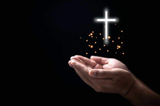 hands folded in prayer on holy bible with cross in church concept for faith, spirituality and religion, man praying on holy bible withcrucifix in morning. man hand with bible and rood praying to god. - rood imagens e fotografias de stock