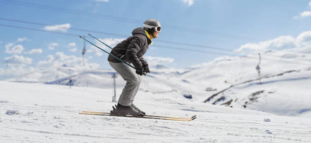 istock Profile shot of a man skiing in a ski resort 1453877962
