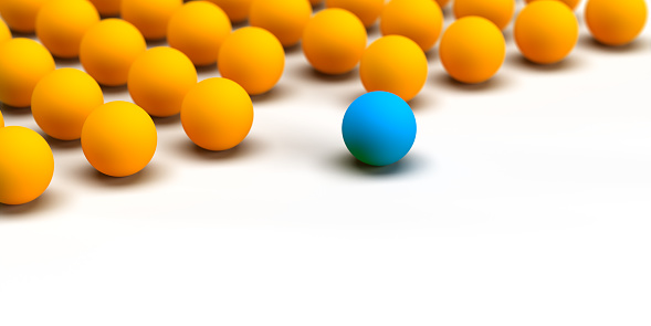 Minimalist leadership and uniqness concept: Authentic 3D illustration. Diverse blue leader ball leading a group of following yellow balls. Creative banner design. Thinking outside the box. Copy space on white background with clipping path for easy edit.