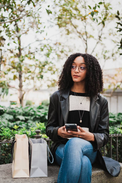 istock Young woman sitting on a bench 1453879541