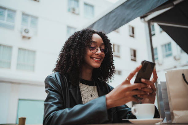 istock Girl sending a text message to friends 1453879551