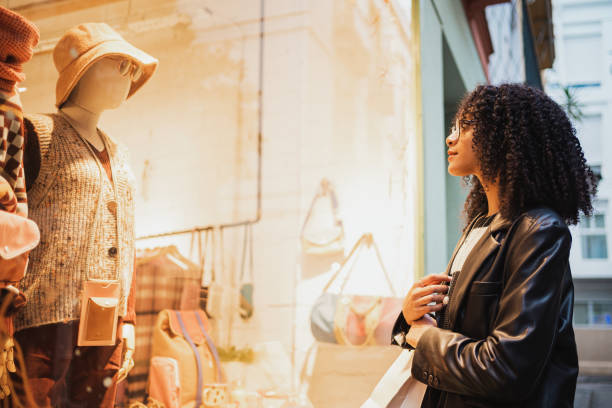 istock Girl looking in a store window 1453879575