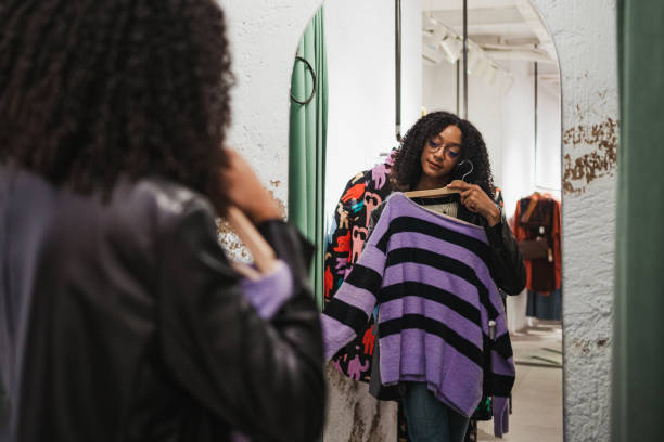 istock Girl trying on a sweater in a fitting room 1453879595