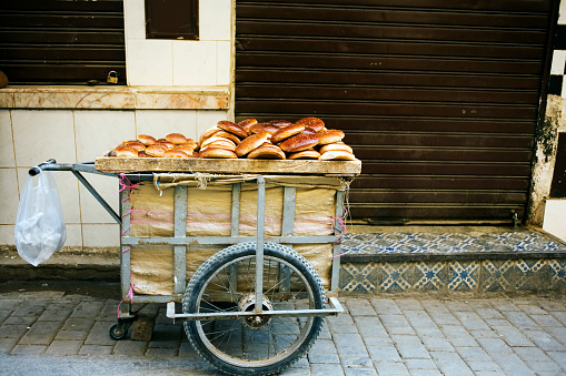 Fresh bread and rolls in a cart on a street