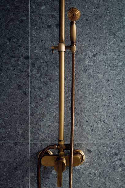 istock Golden shower handle with dark concrete background 1453894294