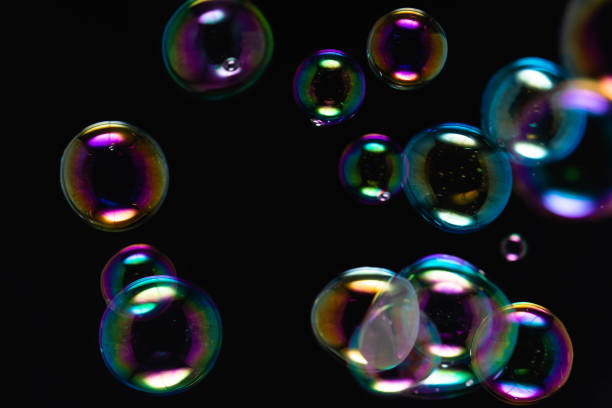 istock Beautiful Colorful Transparent Soap Bubbles on Black Background. Soap Suds Bubbles Water. Abstract Background. 1453900442
