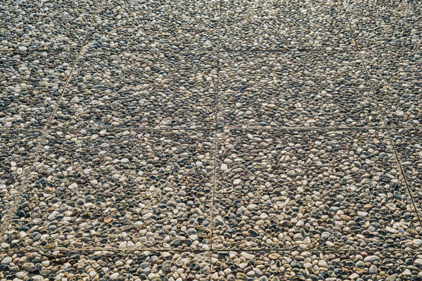 The path is paved with paving slabs made of natural stone, selective focus on paving slabs. Idea for the background and decoration of urban spaces