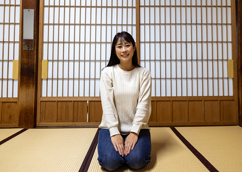Woman sitting on heels in Japanese tatami room