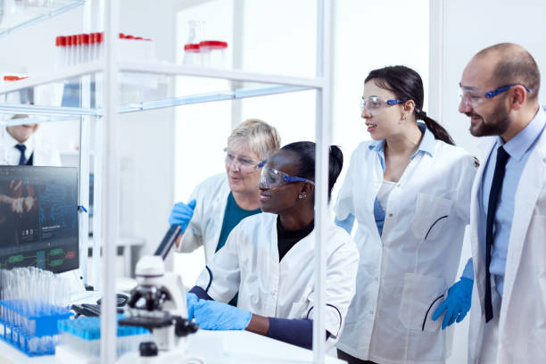 istock Group of multiethnic pharmacy scientists in lab coats working together 1453913127