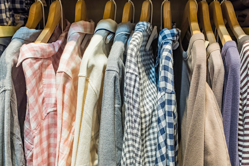 Pajamas in different colors and patterns on hangers