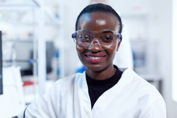 istock African health chemist in biochemistry laboratory looking at camera 1453913456