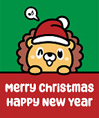istock A cute lion wearing a Santa hat holds a sign and wishes you a Merry Christmas and a Happy New Year 1453913659