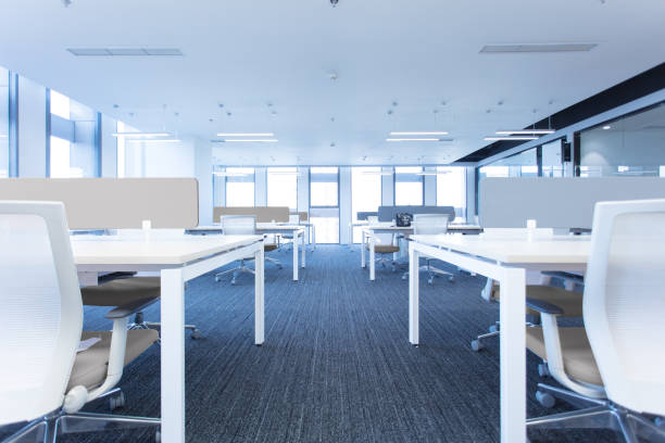 istock Empty modern office interior with tables and chairs on both sides of the corridor 1453914532