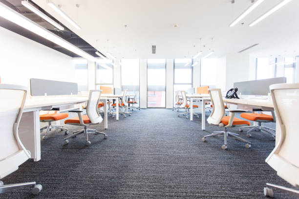 istock Empty modern office interior with rows of desks and chairs 1453914622