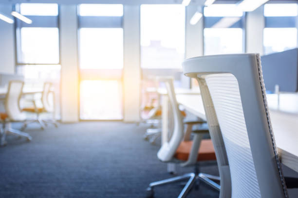 istock Empty modern office interior with tables and chairs on both sides of the corridor 1453914647